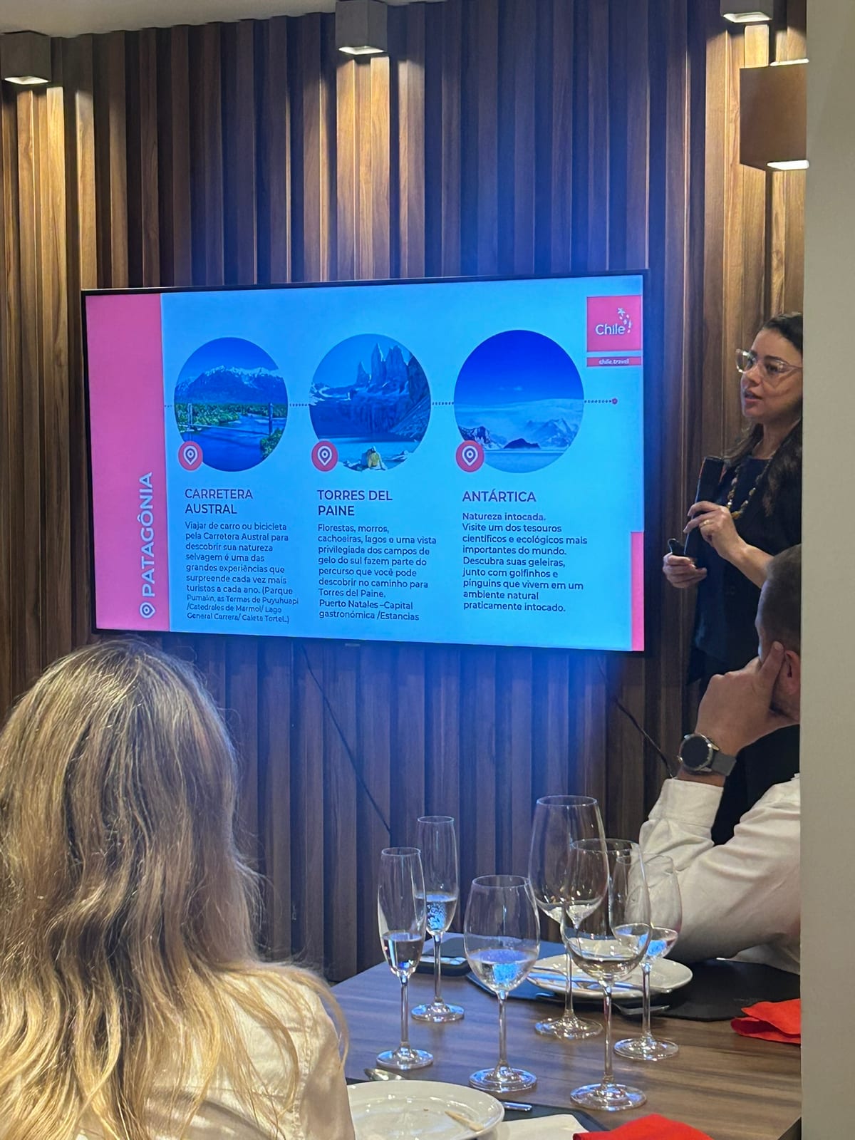 Apresentação sobre destinos do Chile, com Carretera Austral, Torres del Paine e Antártica na tela, durante o evento de 21 de setembro no El Vinos Gastrowine.
